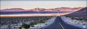 Beautiful, colorful seemingly endless straight road through partial desert with a mountain range in the background. Symbolism for knowing where you are headed with your financial planning.